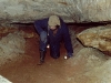 Пилигрим на выходе из Кошачьего лаза. Пещера Помойка. 2000 год.